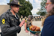 Illinois State Police Lt. Col. Jason Bradley (left) speaks with the Rev. Hannah Kardon, a United Methodist pastor who was among a group of clergy on Oct. 10 asking to bring Holy Communion to detainees in the U.S. Immigration and Customs Enforcement facility in Broadview, near Chicago. The following day another group of clergy also made the same request. Both times Bradley reached out to ICE officials, who denied the clergy entry. Photo by the Rev. Britt Cox, First United Methodist Church in Evanston, Ill. Illinois State Police Lt. Col. Jason Bradley (left) speaks with the Rev. Hannah Kardon, a United Methodist pastor who was among a group of clergy on Oct. 10 asking to bring Holy Communion to detainees in the U.S. Immigration and Customs Enforcement facility in Broadview, near Chicago. The following day another group of clergy also made the same request. Both times Bradley reached out to ICE officials, who denied the clergy entry. Photo by the Rev. Britt Cox, First United Methodist Church in Evanston, Ill.