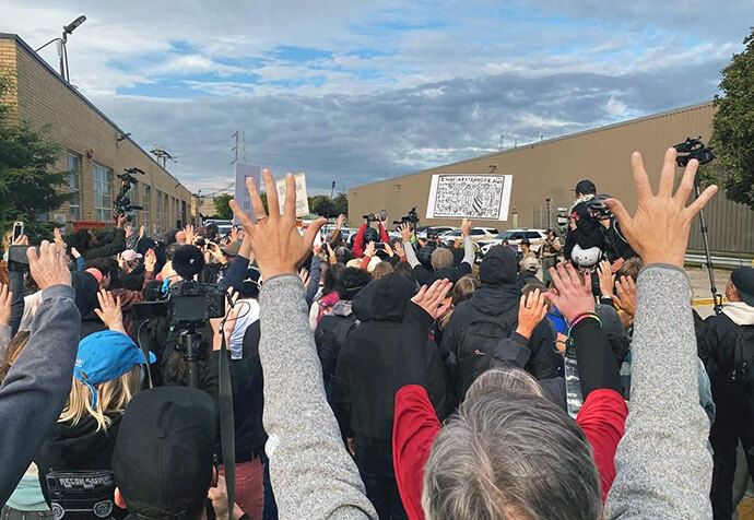 People pray and record what they can outside the U.S. Immigration and Customs Enforcement facility in Broadview, Ill., a Chicago suburb. United Methodists across the Chicago area are doing what they can to protect neighbors and offer comfort amid threats of militarization and an onslaught of masked federal agents. Photo by the Rev. Britt Cox, First United Methodist Church in Evanston, Ill.