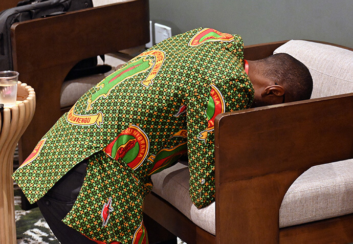 A pastor kneels and prays Oct. 9 during the Facing the Future 2025 conference in Los Angeles. Photo by Jim Patterson, UM News.