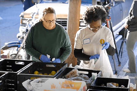 Volunteers prepare food to distribute at the Belmont Food Pantry, supported by Belmont United Methodist Church in Richmond, Va. Belmont is the largest food pantry in Richmond. Screengrab courtesy of the Virginia Conference via YouTube by UM News.