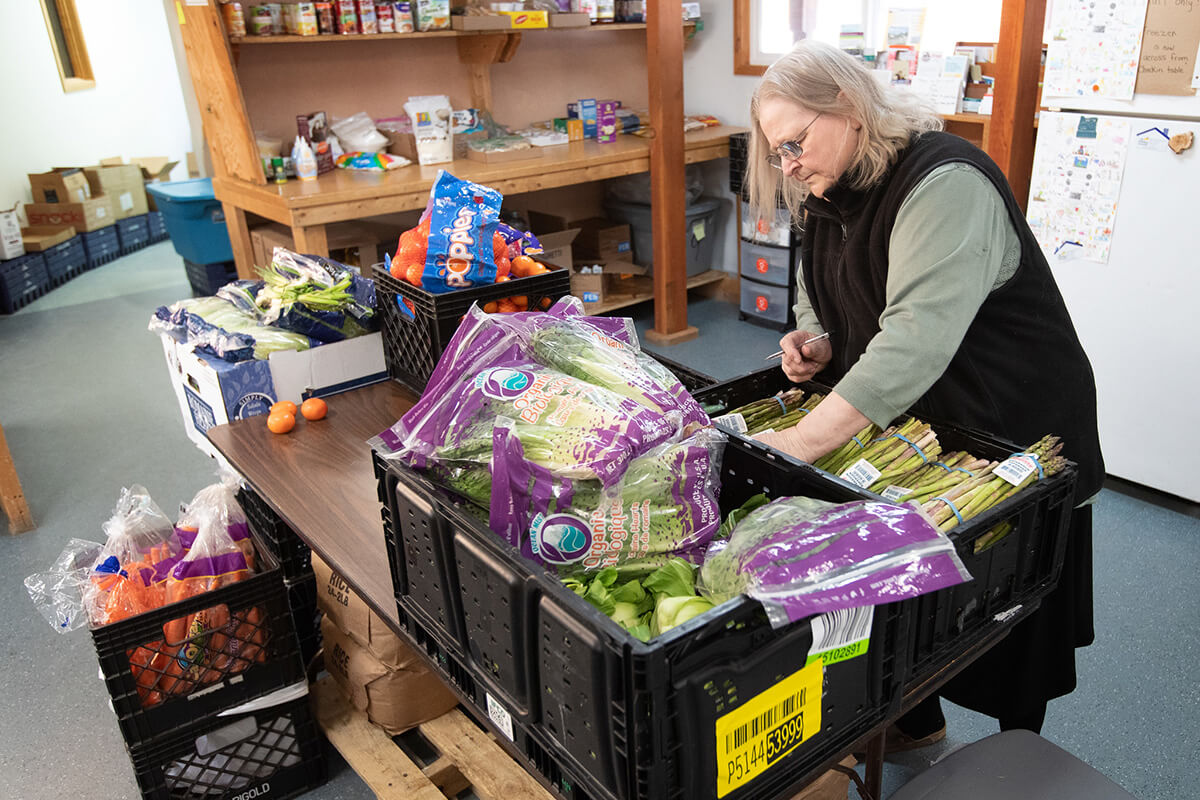 Ola Williams sorts through donated produce at the Willow Community Food Pantry in Willow, Alaska. Williams serves as director of the pantry, a ministry of Willow United Methodist Church. 2023 file photo by Mike DuBose, UM News.