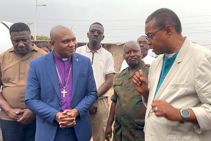 The Rev. Alpher K. Sylvester of the New York Conference (right) talks with Bishop Nelson Kalombo Ngoy (second from left) during a visit to communities in the Tanganyika Episcopal Area in Congo. A delegation from the New York Conference made the trip to strengthen partnerships and see the church’s work and challenges in the region. Ngoy served in New York for more than 16 years before being elected to the episcopacy. Photo by Chadrack Tambwe Londe, UM News.