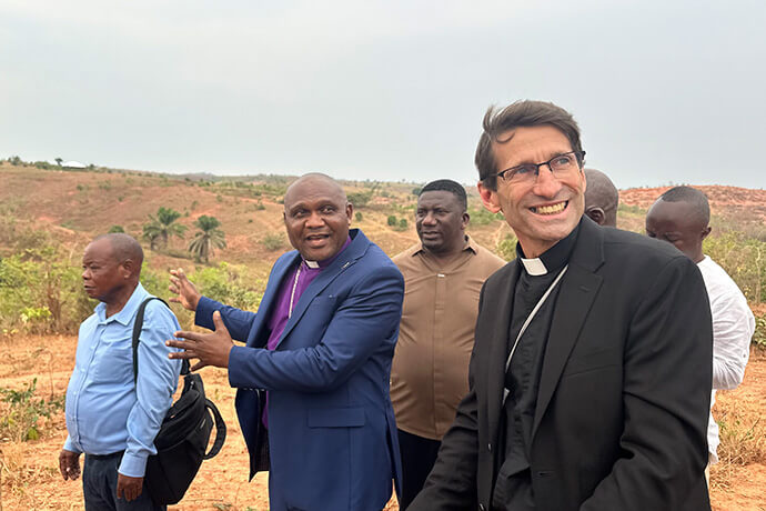 Bishop Nelson Kalombo Ngoy of Tanganyika (center) leads guests from the New York Conference, including the Rev. Richard L. Hanse (right), on a tour of the site where he plans to build a modern hospital in Kalemie, Congo. Ngoy said access to medical care is among the top challenges facing communities in his episcopal area. Photo by Chadrack Tambwe Londe, UM News.