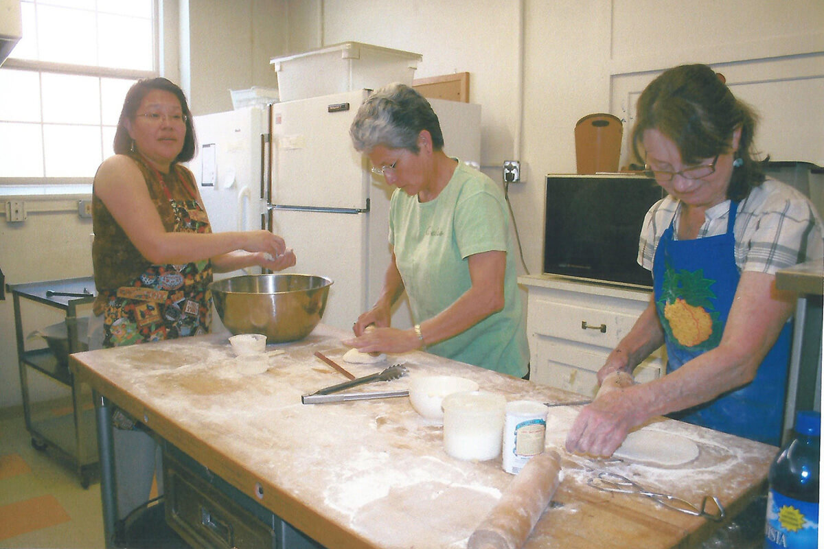 Barbara Braided Hair, left, teaches members of First United Methodist Church in Sheridan, Wyo., how to make fry bread. Barbara is the late wife of Otto Braided Hair Jr., a Sand Creek Massacre descendants representative of the Northern Cheyenne tribe in Lame Deer, Mont., who helped educate church members about the 1864 massacre led by Methodists. The dialogue sparked a two-decade relationship between the church’s Native American Committee and the Northern Cheyenne tribe. File photo courtesy of First UMC Sheridan.