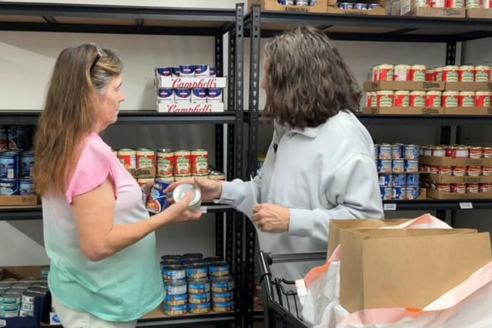 Kathey Smith shops with a volunteer at the Rhea House, a free grocery store in Tennessee operated by United Methodist Reelfoot Rural Ministries and Dyersburg First United Methodist Church. Video image by Lilla Marigza, UM News.