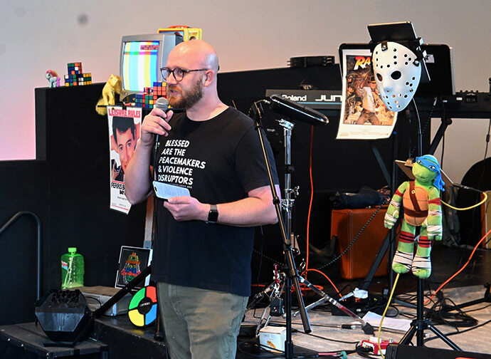 The Rev. Joe Graves welcomes members of Cityview Church and community residents to a 1980s-themed gathering Sept. 20 at Wild Goose Creative in Columbus, Ohio. Graves has written a book called “The Progressive Planter” that offers instructions for establishing an inclusive, theologically healthy church with community impact. Photo by Jim Patterson, UM News.