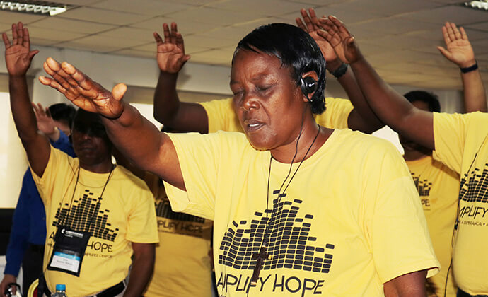 Gefanie Buntu Ngoie from Congo prays during the United Methodist Radio Network meeting in Luanda, Angola, in 2018. The network, rebranded as the United Methodist Broadcast Network in 2023, recently gathered for its annual meeting in Zimbabwe. File photo by Taurai Emmanuel Maforo, UM News. 