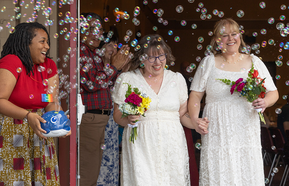 Lindsey Dye (center) and Laura Smotherman are showered with bubbles after they renewed their wedding vows at Edgehill United Methodist Church in Nashville, Tenn. Photo by Mike DuBose, UM News.