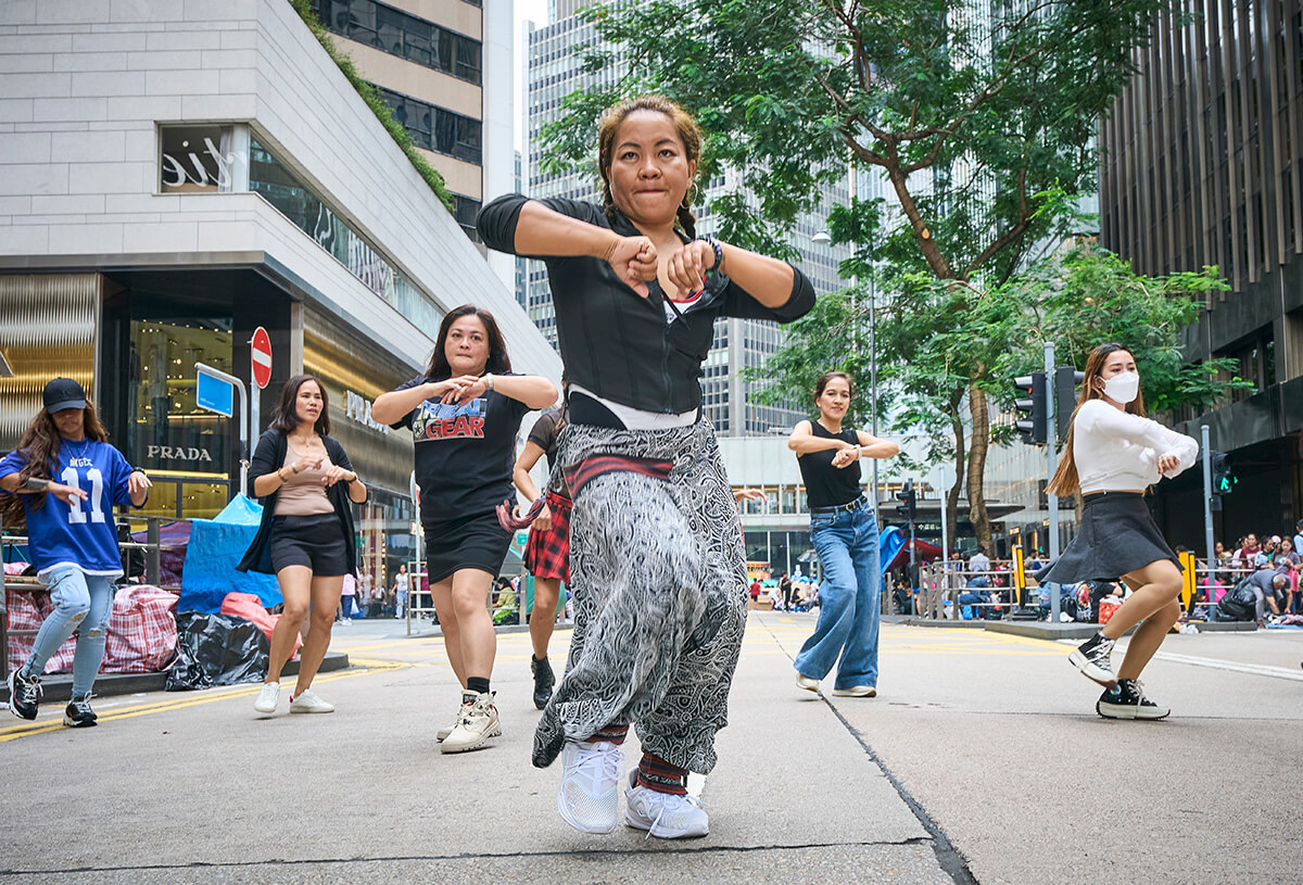 Members of Star Pinoy, a Filipina dance group made up of migrant workers, practice on Chater Road during their only day off. Photo by Paul Jeffrey, UM News.