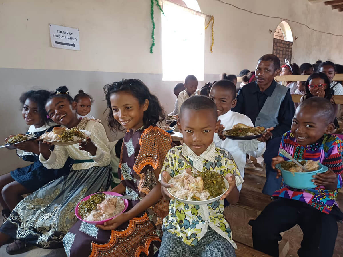 Church and community members share a meal during a Christmas celebration at the United Methodist Church in Ambodifasika, Madagascar. Photo by Esdras Rakotoarivony, UM News.