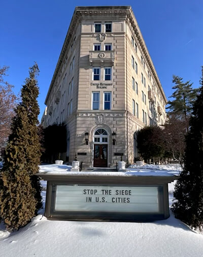 The United Methodist Building in Washington, D.C., urges “Stop the Siege in U.S. Cities.” The building, which is adjacent to the U.S. Capitol and Supreme Court, is the headquarters of the United Methodist Board of Church and Society. Photo courtesy of Church and Society.