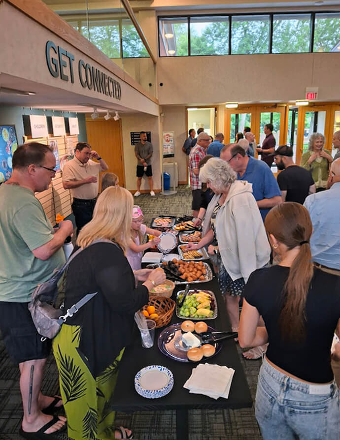 Attendees at First United Methodist Church of Crystal Lake, Ill. enjoy fellowship and food in the “Wesley Café” in the church’s narthex after Sunday morning services. The “Café” has becoe a favorite way for members and visitors to build community with one another. 2024 file photo courtesy of First United Methodist Church of Crystal Lake, Ill.