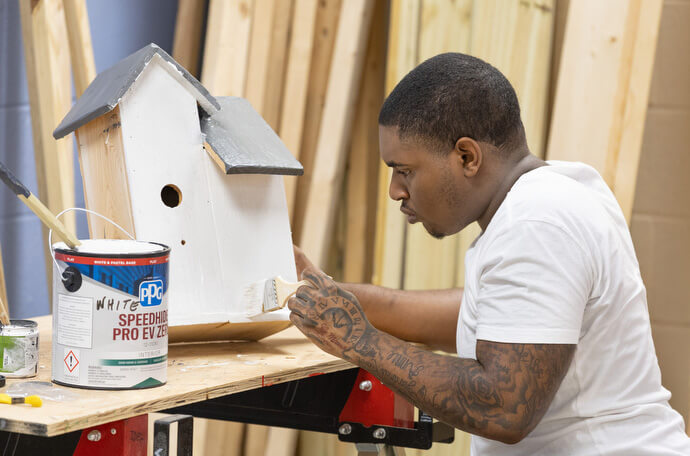 Angelo Gardner paints the birdhouse he built in the vocational training program of the Judge Dinkins Educational Center, housed at McKendree United Methodist Church in Nashville, Tenn. McKendree’s pastor, the Rev. Stephen Handy, envisions more United Methodist churches using the spare space in their buildings to build partnerships in their neighborhoods. Photo by Mike DuBose, UM News.