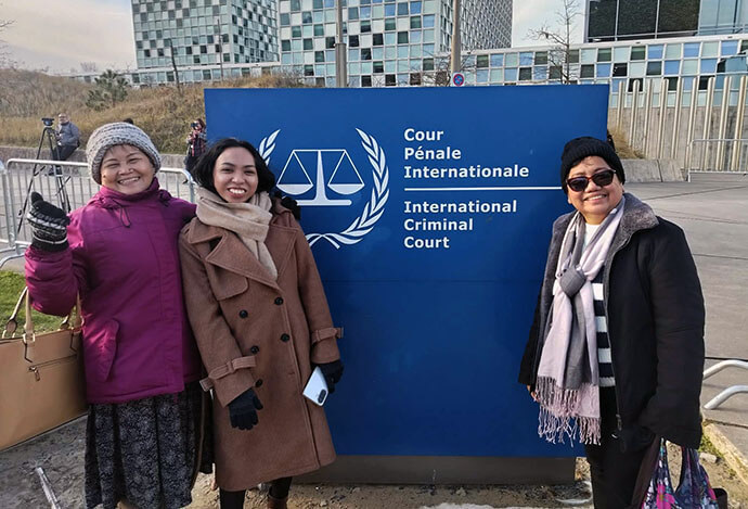 (From left) Nay Llore Pasco, mother of two extra-judicial killing victims; Sheerah Escudero, the sister of Ephraim Escudero, a victim of extra-judicial killing; and Deaconess Rubylin G. Litao stand in front of a sign for the International Criminal Court at The Hague on Feb. 23, after the first day of the confirmation of charges hearing for former Philippine President Rodrigo Duterte. Photo courtesy of Rubylin Litao.