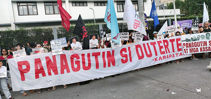 Demonstrators hold a sign reading “Panagutin si Duterte” (Hold Duterte Accountable) at a protest on March 11 in Quezon City, Philippines. Photo courtesy of Rubylin Litao.