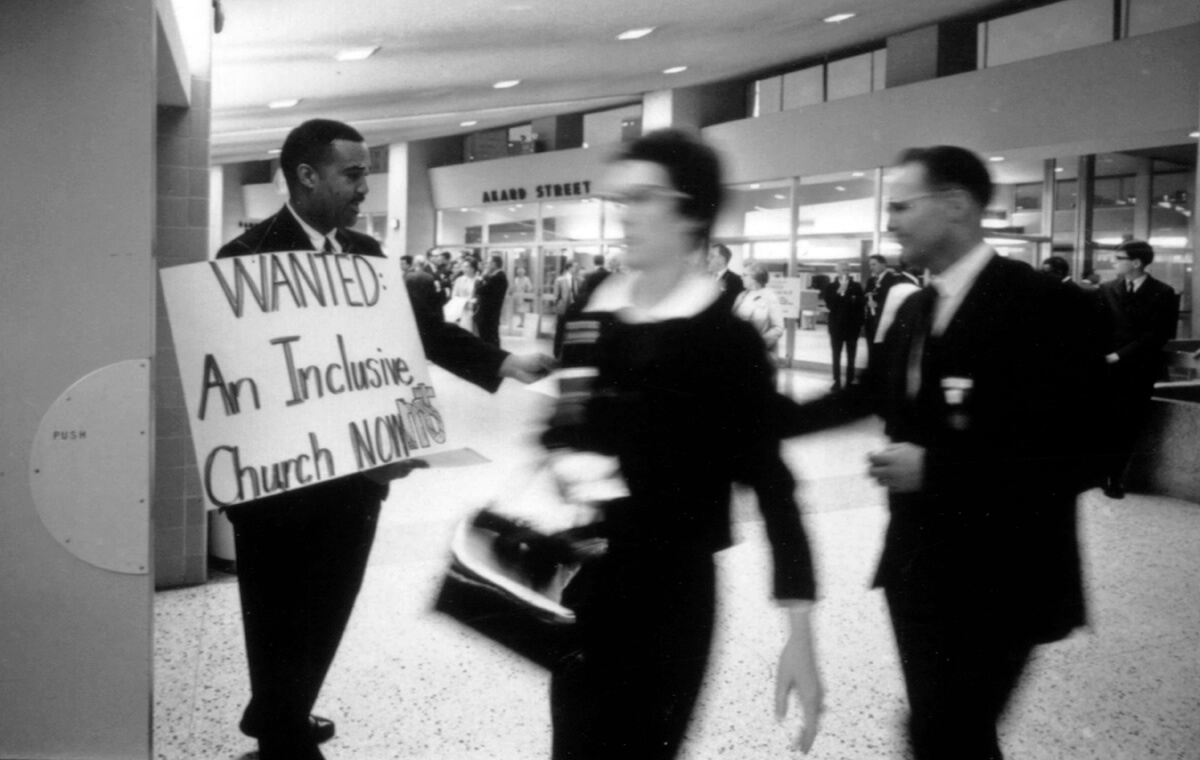 A protester holds a sign seeking an end to racial segregation in the Methodist Church during the 1968 General Conference in Dallas. The conference merged the denomination with the Evangelical United Brethren Church, creating The United Methodist Church, and did away with the racially segregated Central Jurisdiction. A new book by the Rev. Bonnie McCubbin details the long road for Black Methodists to get full equality in the denomination. Photo courtesy of United Methodist Commission on Archives and History.