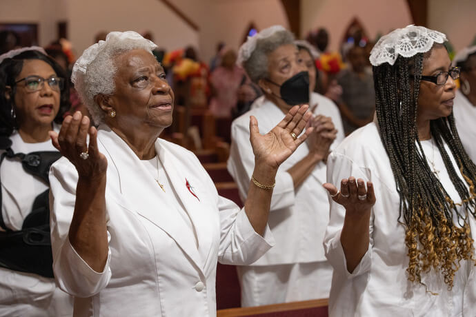 Atha Brown (left, front) joins with other communion stewards in praise during worship at Hartzell Mt. Zion United Methodist Church in Slidell, La., in 2025. File photo by Mike DuBose, UM News.