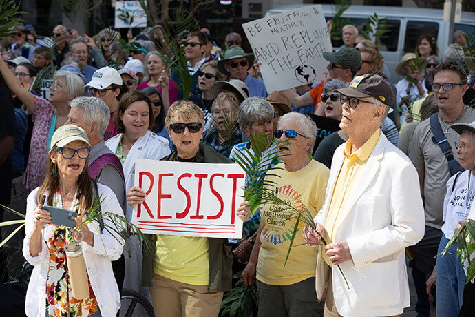 Participants in a Palm Sunday Witness gather outside the Fred D. Thompson Federal Building in Nashville, Tenn. 