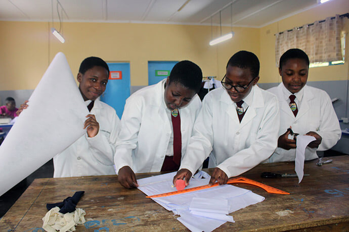 Students at United Methodist Murewa High School in Murewa, Zimbabwe, measure a garment they want to cut in the school’s uniform factory. Photo by Kudzai Chingwe, UM News.