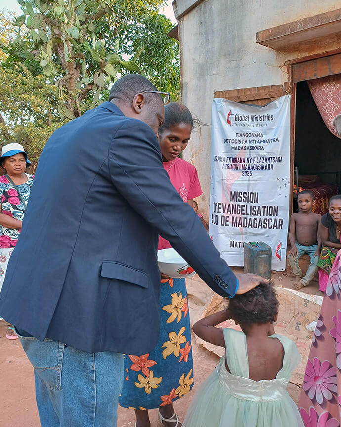 The Rev. Éric Kalumba, a missionary with the United Methodist Board of Global Ministries, baptizes a child during the church’s evangelism journey in Andranovory in southern Madagascar. Kalumba baptized and confirmed individuals in many of the locations where the outreach took place. Photo by Esdras Rakotoarivony, UM News.