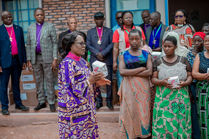 Bishop Mujinga Kashala of the South Congo/Zambia Episcopal Area presents a reusable feminine hygiene kit to beneficiaries at Burundi’s Musenyi camp. The sustainable kits aim to restore the dignity of girls and women at the site who often had to remain isolated during their menstrual cycles due to a lack of resources. Photo courtesy of the communications department of the Burundi-Rwanda Episcopal Area.