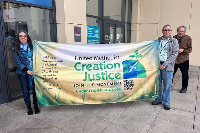 From left: Denise Honeycut), Pat Watkins and Dan Joranko of the UM Creation Justice Movement greet attendees of the 2024 General Conference in Charlotte, N.C. Photo courtesy of UM Creation Justice Movement.