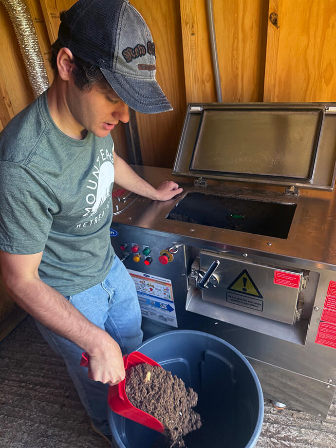 Chris Cook, compost program coordinator at Mount Eagle Retreat Center in Clinton, Ark., attends to composting. File photo courtesy of Mount Eagle Retreat Center.