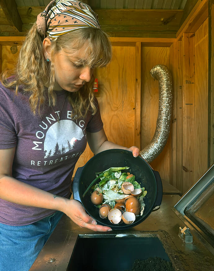 Hannah Cook, assistant director of Mount Eagle Retreat Center in Clinton, Ark., prepares egg shells and other garbage for composting. File photo courtesy of Mount Eagle Retreat Center.