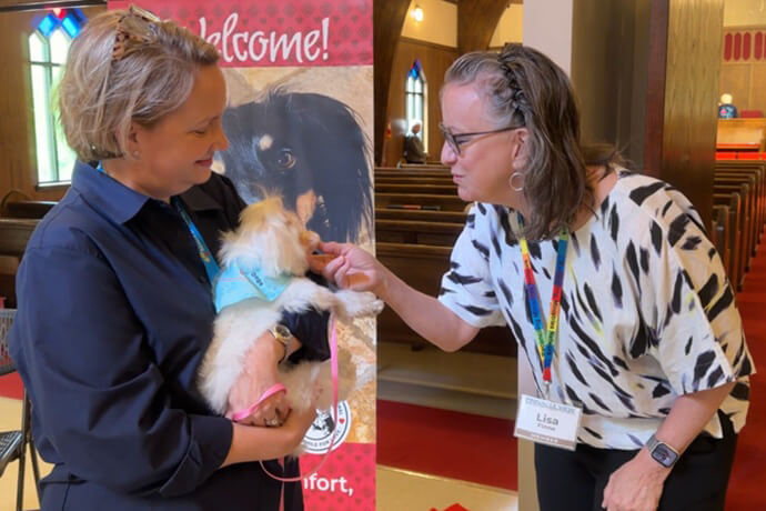 Holly Petti and her dog Paisley chat with people entering the Sanctuary at Pinnacle View United Methodist Church in Little Rock, Ark. The church has a designated dog greeter every Sunday in addition to numerous pet outreach ministries the congregation offers. Image from video by Lilla Marigza, UM News. 