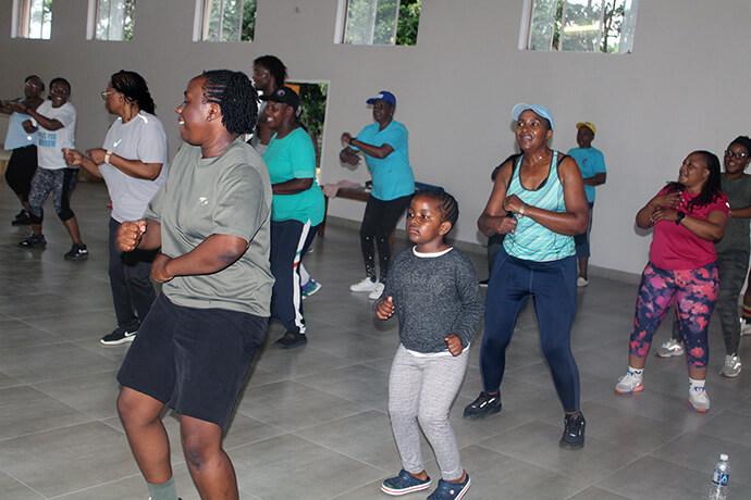 Blessing Buta (black shorts), Milcah Mudekunye (light green tank top) and Annie Buta (maroon top) perform dance moves during a Zumba class at Chisipiti United Methodist Church in Harare, Zimbabwe. People of all ages are enjoying the classes. Photo by Kudzai Chingwe, UM News.