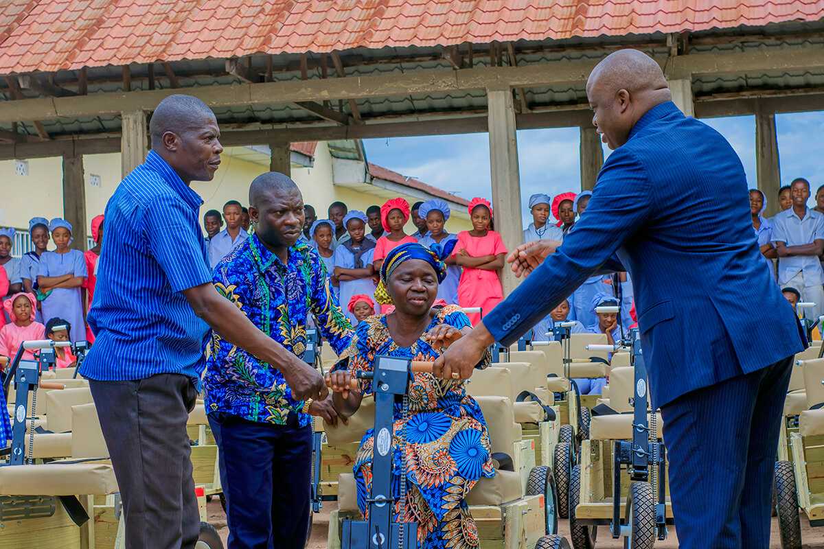 Bishop Mande Muyombo (right) helps a woman settle into her new adapted bicycle in Kamina, Congo. At left are lay leader Kiluba Yolola Elie and Pastor Joseph Kasongo Mukolomone. The United Methodist Church distributed 97 bicycles to people living with disabilities in the North Katanga Conference. The initiative is funded by United Methodist partners in the North Georgia Conference. Photo by Yamba Kisonga Barthélémy, UM News.