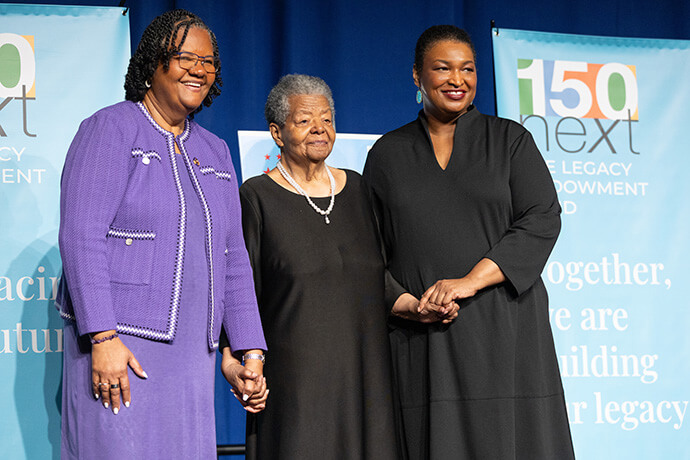 Speakers at the United Women in Faith Legacy Dinner gather for a photo during the group’s 2026 Assembly in Indianapolis. From left are Sally Vonner, top executive of United Women in Faith; Elizabeth Eckford, member of the Little Rock Nine; and Stacey Abrams, author and voting rights activist. Photo by Mike DuBose, United Women in Faith.