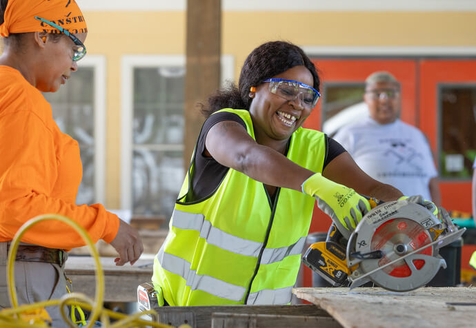 Quasha Johnson smiles after learning to use a circular saw. 