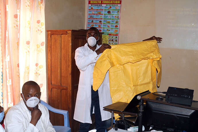 Dr. Damas Lushima with The United Methodist Church’s East Congo Health Board inspects personal protective equipment during a medical training session in Bukavu, Congo, in April 2022. Lushima is helping to coordinate the United Methodist response to a fast-spreading Ebola outbreak in the region. There are more than 1,000 suspected cases of the Bundibugyo strain of Ebola in the Democratic Republic of the Congo, and 220 suspected deaths, according to the World Health Organization. File photo by Philippe Kituka Lolonga, UM News.