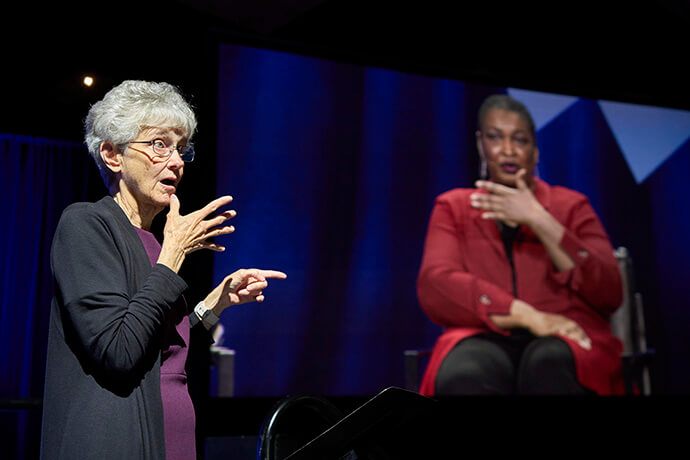Retired United Methodist Bishop Peggy A. Johnson provides sign language interpretation as Stacey Abrams addresses the United Women in Faith Assembly 2026 in Indianapolis on May 16. Photo by Paul Jeffrey, United Women in Faith.