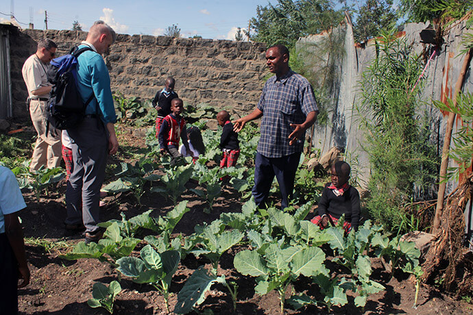 John Mueke Lavuta, pastor-in-charge at Parkview Kitengela United Methodist Church, shows off the garden at the church’s Mumo Educational Center. The garden feeds the 36 children enrolled at the school. Photo by Kudzai Chingwe, UM News. 