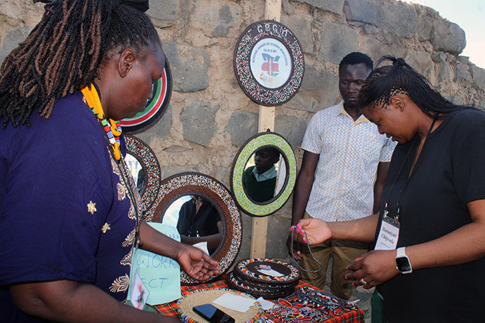 Joyce Syokau (left), president of the Nairobi District’s women’s organization, tells Hamunyari Chigwada, Global Ministries board member, about the wares created by church members at Parkview Kitengela United Methodist Church. Sales of the beadwork fund church ministries and help vulnerable members. Photo by Kudzai Chingwe, UM News. 
