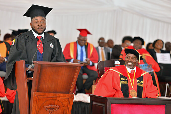 Genius Mukichi, class of 2026 valedictorian, addresses his colleagues and guests during the United Methodist university’s graduation ceremony on June 6. He urged his classmates to transform communities and uplift others. Photo courtesy of the Africa University Public Affairs Office.