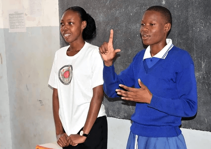 Neema Ndalawa (left) presents a lesson on human rights and health at Buhongwa Secondary School in Mwanza, Tanzania, as student Elizabeth Zacharia translates in sign language. The United Methodist Church’s Yatosha Deaf Ministry provides training, mentorship and support for Deaf students at the school and across the Tanzania Conference. File photo by Robert Aloyce, UM News.
