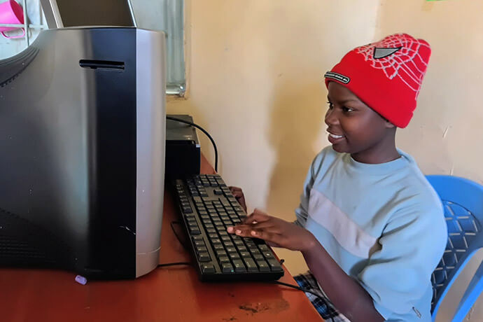 Student Faith Mueni practices her computer skills at Parkview Kitengela United Methodist Church in Nairobi. The training is part of the church’s No Girl No Cry ministry, which empowers girls through education and mentorship. Photo by Jackline Mwende. 