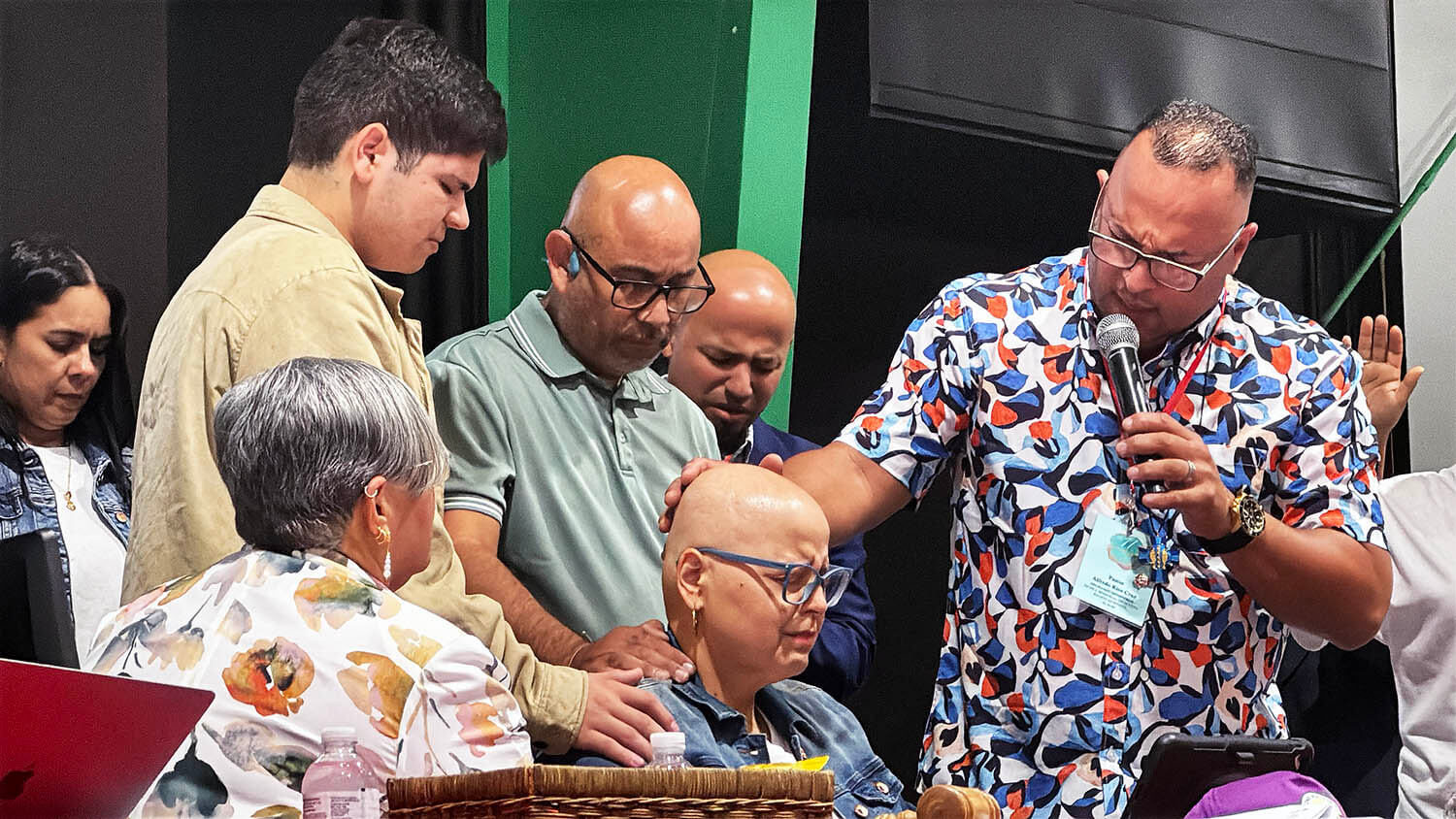 Church leaders gather in prayer following the ministry report presented by Vilmarie Rivera Sierra, executive director of Rebuilding Communities with Hope and the Methodist Church's Center for Advocacy and Comprehensive Services for Women. Photo by the Rev. Gustavo Vásquez, UM News.