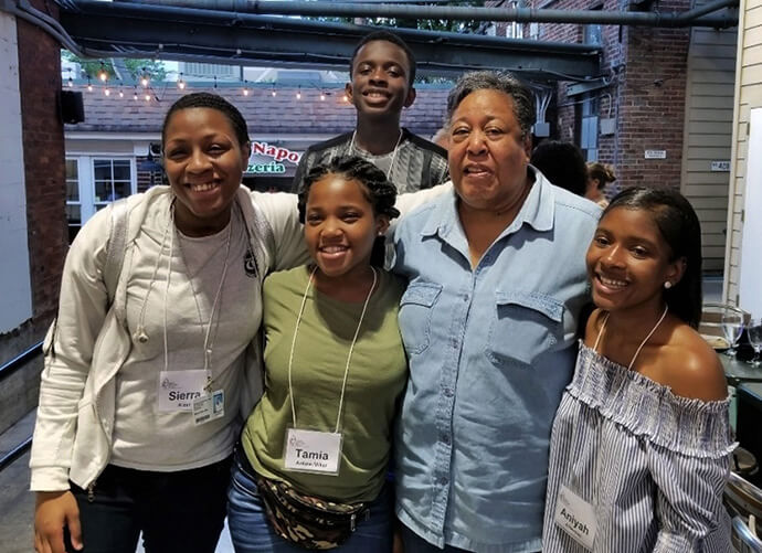 Clara Ester poses for a photo with Nashville Freedom School Partnership students. She visited with students to learn about their work in disrupting the cradle-to-prison pipeline. Ester was a tireless advocate for those on the margins. Photo by M. Garlinda Burton. 