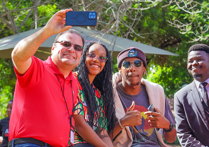 Bishop Héctor A. Burgos-Núñez takes a selfie with Africa University students during a February 2025 visit to the main campus in Mutare, Zimbabwe. Photo courtesy of Africa University.