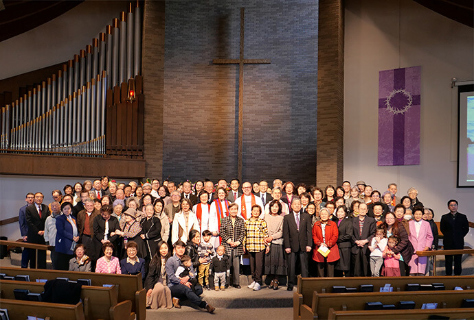 Des amis, des membres de l'Église Méthodiste Unie coréenne de Sammool et l'Evêque Dan Schwerin, de la Conférence du nord de l'Illinois, se sont réunis à l'issue de la cérémonie d'agrément de la paroisse, en mars 2024. Bien que cette communauté religieuse ait commencé à se réunir dès 1996 pour venir en aide aux immigrés coréens de l'agglomération de Chicago, l'église n'a été officiellement agréée par la conférence qu'il y a deux ans. Photo gracieusement fournie par l'Église Méthodiste Unie coréenne de Sammool.