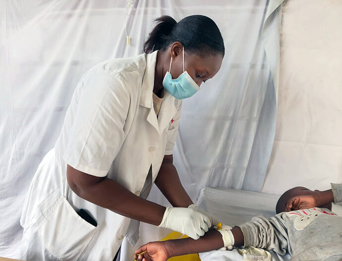 Dr. Rachael Mbinda attends to a patient diagnosed with malaria during a United Methodist medical camp held July 24-26 in Mwakirunge, Kenya. Many residents in the Mwakirunge community put off medical care due to the long distance to health facilities and the high costs of accessing treatment. Photo by Selina Mutua, UM News.  
