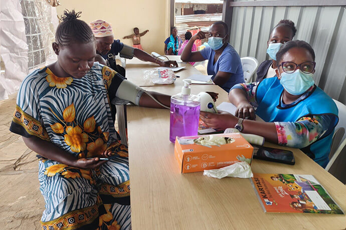 Dr. Jardin Mrisa (right) checks Eunice Munga’s blood pressure during a United Methodist health clinic in the Kilifi District of Kenya. Volunteer medical teams offered consultations, treatment, laboratory services, mental health assessments and medication free of charge. Photo by Selina Mutua, UM News.  