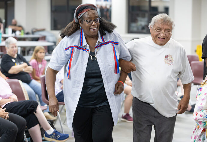 Sonya Marable and Cubert Bell Sr. take part in a friendship dance during Native Moccasins Rock. 