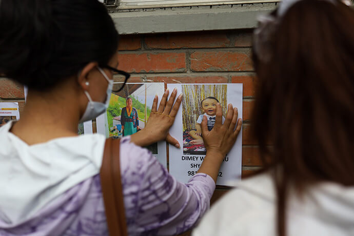 A family member displays a photograph of a missing relative at Tribhuvan University Teaching Hospital in Kathmandu, Nepal, on Aug. 28. Families of people missing after floods and landslides in Rasuwa have come to the hospital seeking information about their loved ones. Photo by Subaas Shrestha, NurPhoto via AP.