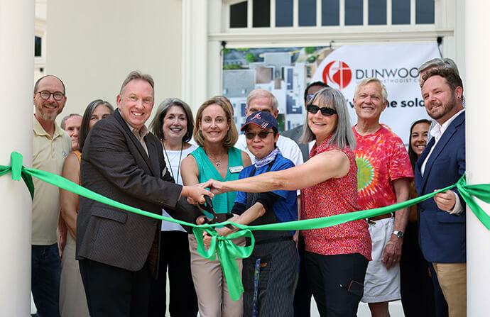 City officials and members of Dunwoody United Methodist Church in Dunwoody, Ga., cut the ribbon to celebrate the completion of the installation of solar panels on the church’s roof in 2025. In the front row, from left, are the Rev. Phil Schroeder, Dunwoody’s senior pastor, and Anne Hicks, chair of the church’s sustainability committee. File photo courtesy of Dunwoody United Methodist Church.