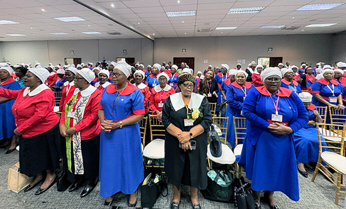 World Federation of Methodist and Uniting Church Women leaders pray for Pamela Saungweme (second from left) and her ministry during the group’s national conference in Harare, Zimbabwe. Photo by Eveline Chikwanah, UM News.